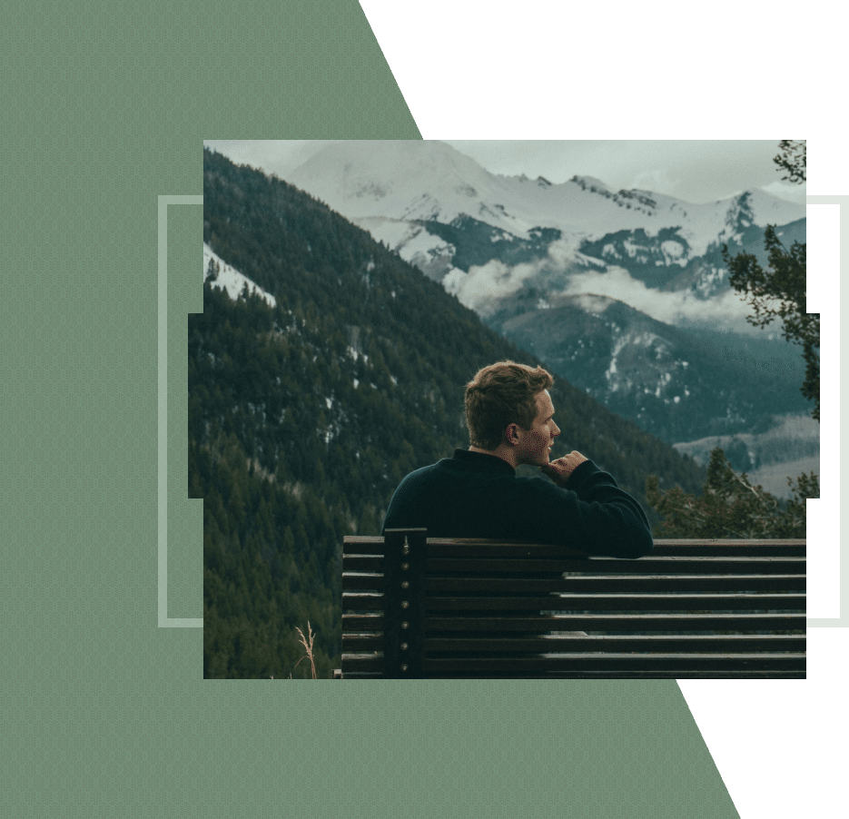 Man sitting on a bench, reflecting in nature, symbolizing healing through depression therapy near me in San Francisco.