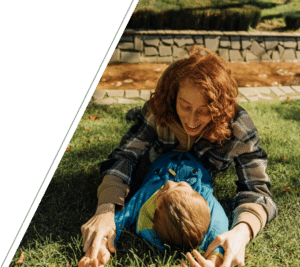 A smiling adult playing with a child, representing therapy for children in San Francisco to support emotional growth and healing.