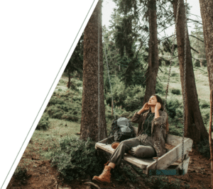 A woman relaxing on a swing in nature, symbolizing stress relief through anxiety therapy in San Francisco.
