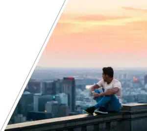 Man quietly reflecting above city, finding peace after loss with San Francisco grief counseling