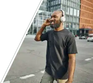 Smiling man with headphones enjoying music, embracing focus through ADHD therapy San Francisco