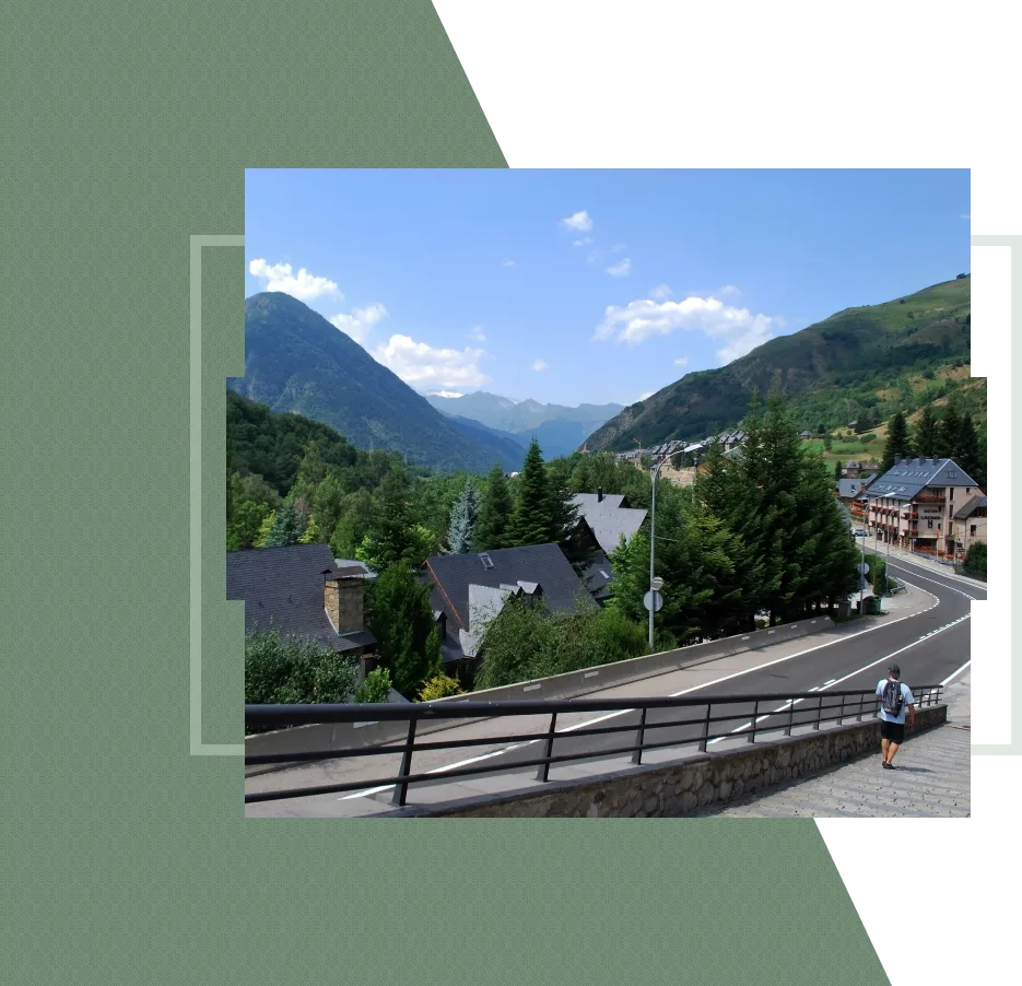 A man walks on a road in a mountain village