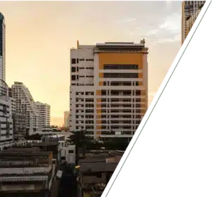 A mix of high-rise and low-rise buildings in a city at sunset