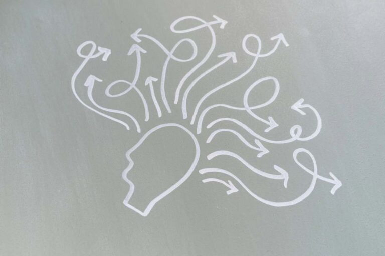 Simple outline of a head with swirling arrows, representing racing thoughts and persistent worry in anxiety.