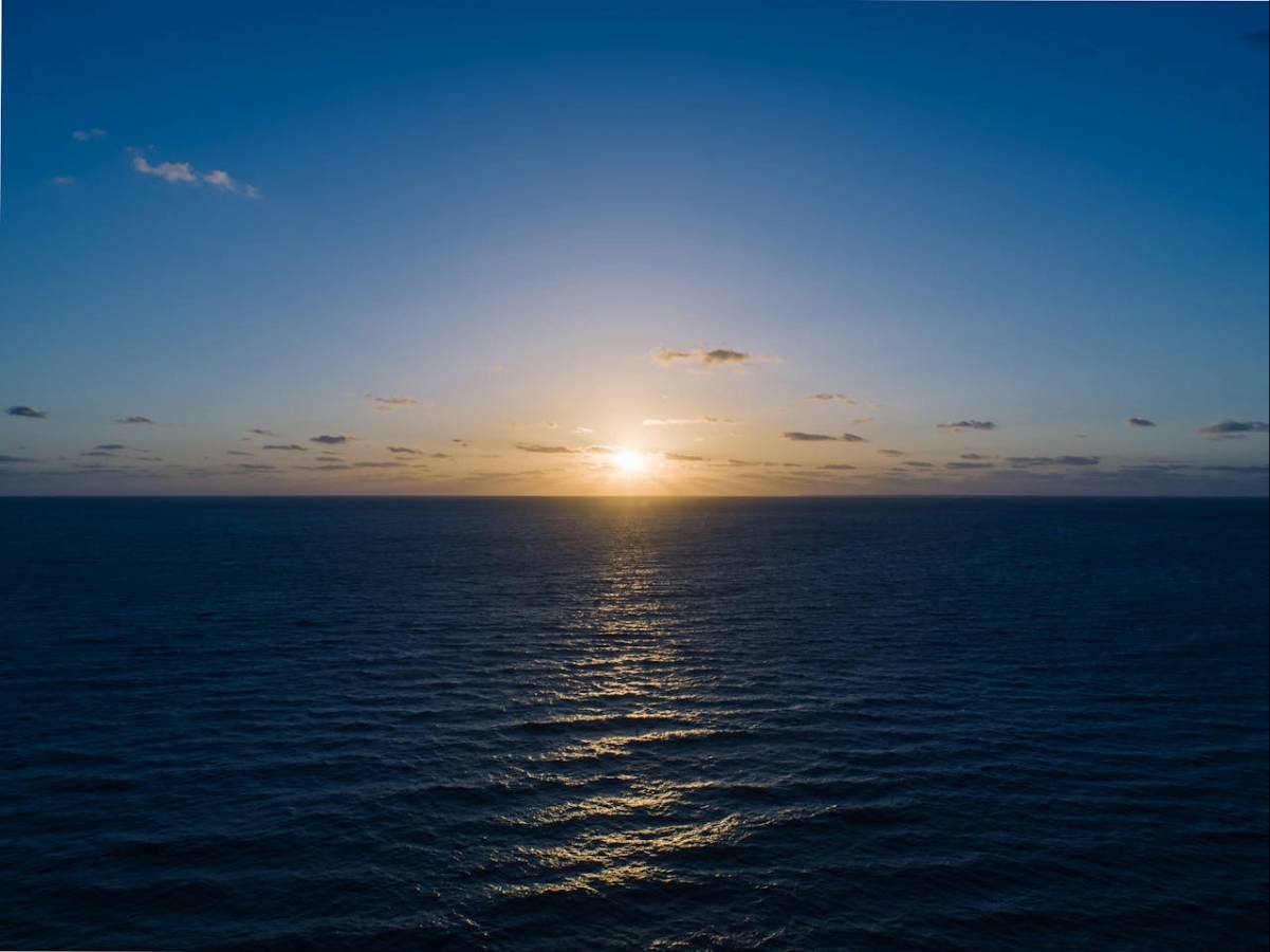 Peaceful ocean sunset with calm waves, representing stress relief, mindfulness, and inner balance.