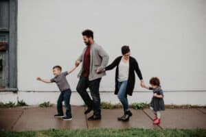 A happy family walking hand in hand, symbolizing support, connection, and the importance of children’s mental health.