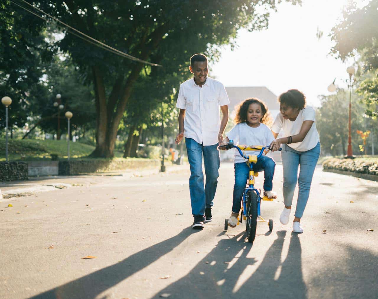 parents-teaching-child-bike-riding-family-support