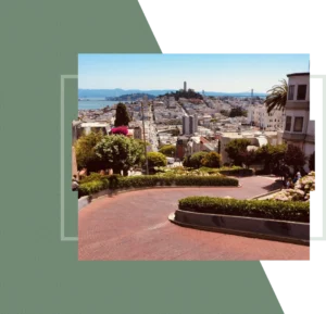 Large steel arch bridge over a blue channel and green forest.