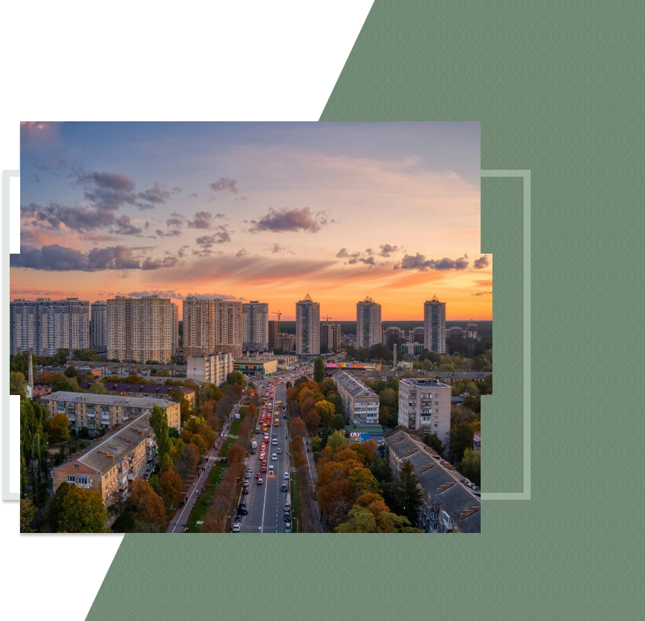 A vibrant city skyline at sunset with a long road