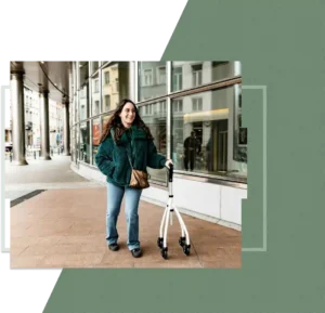 A woman using a walker moving alongside a building, at a steady pace, capturing independence and resilience