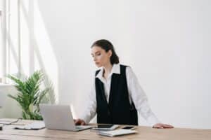 woman working on laptop managing startup stress in office environment