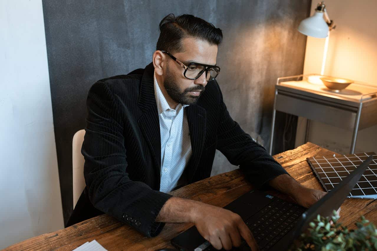 professional man working on laptop experiencing startup work stress