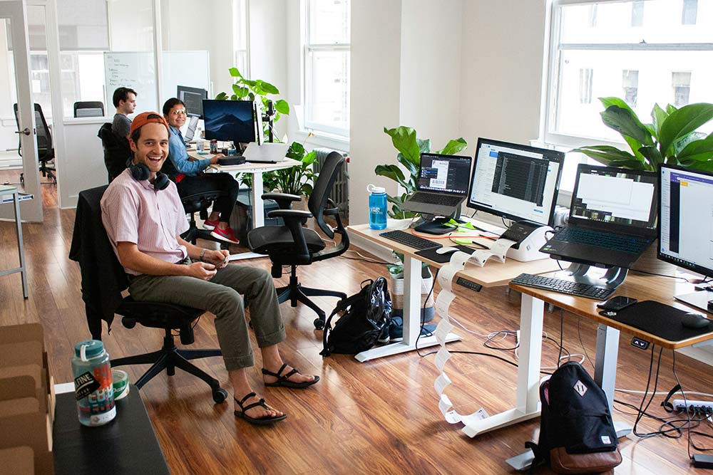man-in-blue-dress-shirt-sitting-on-black-office