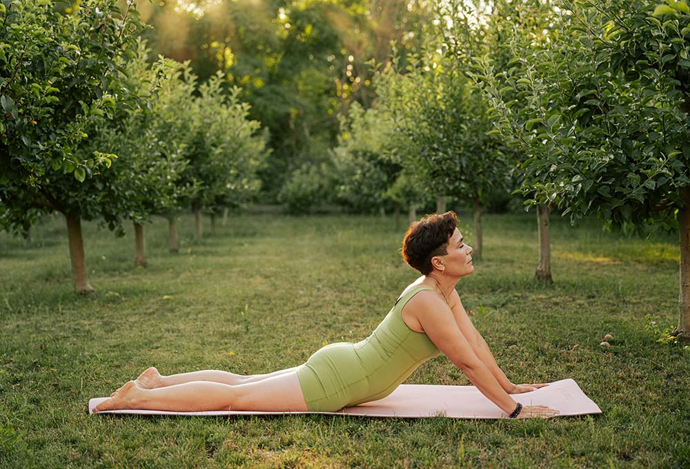 Woman performing cobra yoga pose